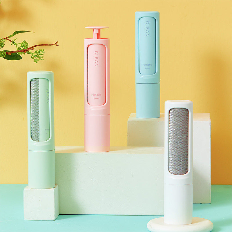 Reusable pet hair roller with silicone roller head and grip handle, on a white background.